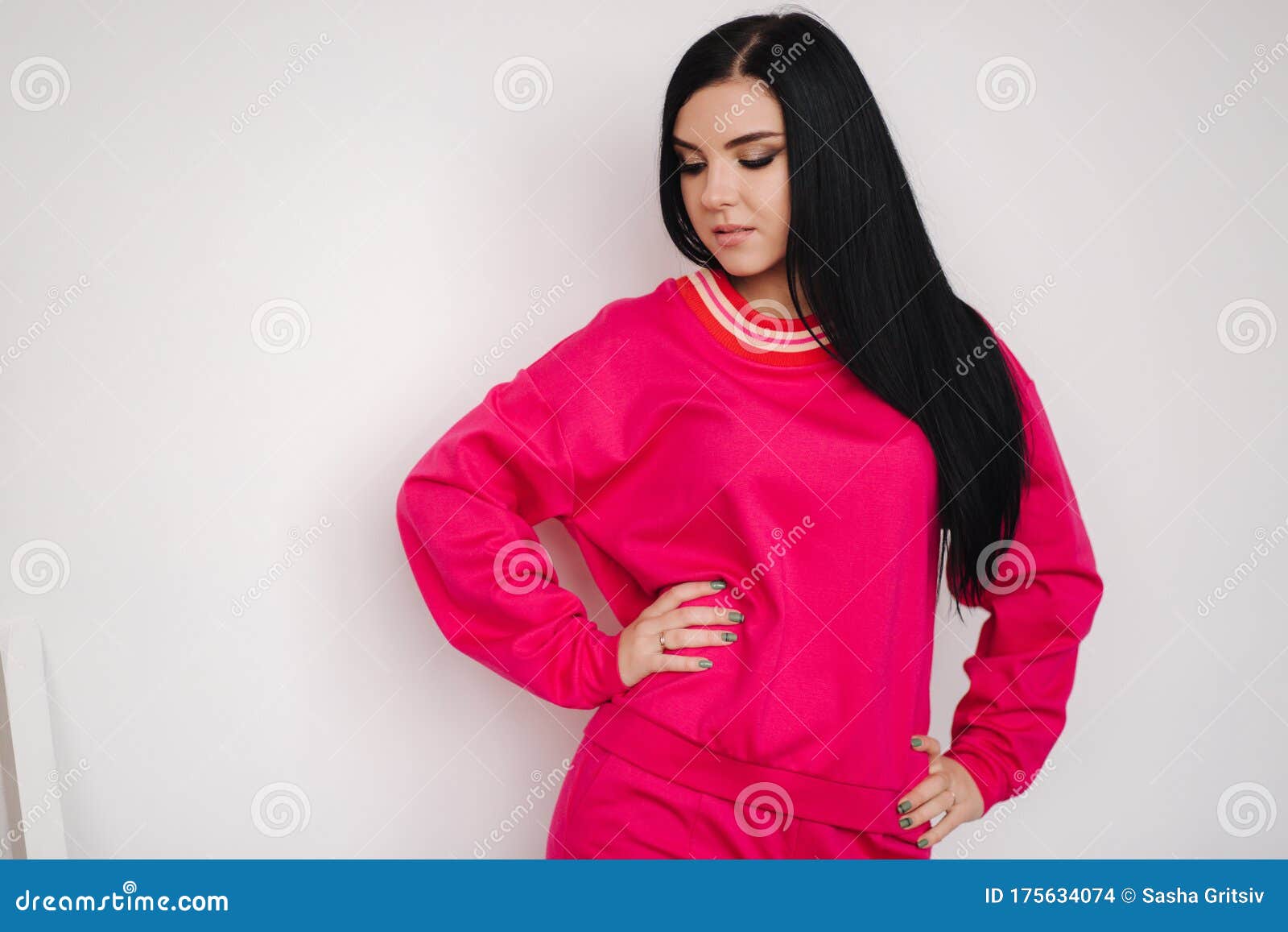 Attractive Young Model in Pink Tracksuit. Woman Demonstrating Clothes ...