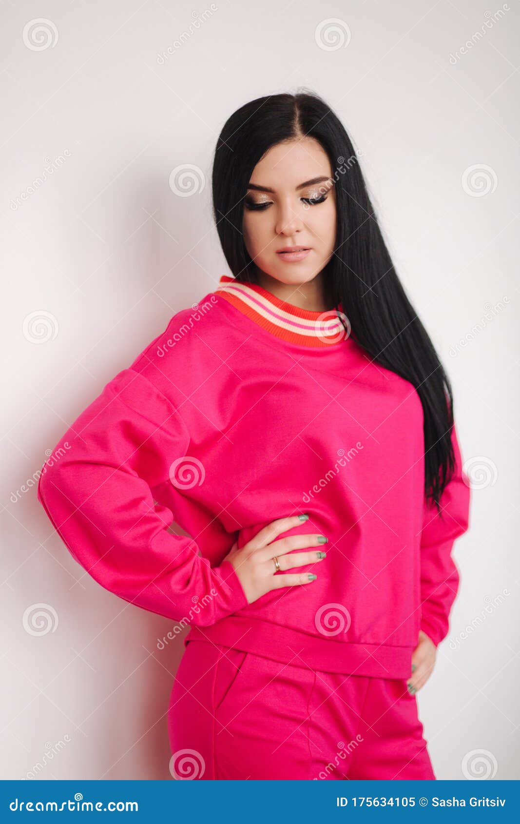 Attractive Young Model in Pink Tracksuit. Woman Demonstrating Clothes ...