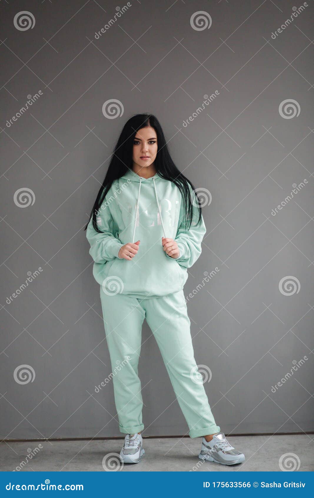 Attractive Young Model in Tracksuit. Woman Demonstrating Clothes in ...