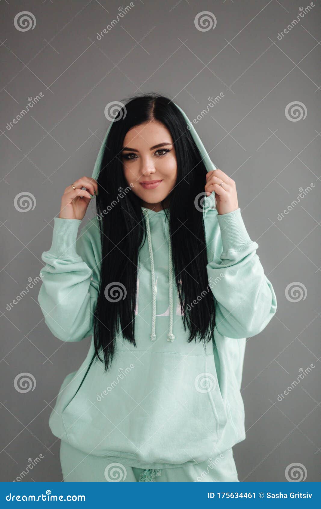Attractive Young Model in Tracksuit. Woman Demonstrating Clothes in ...