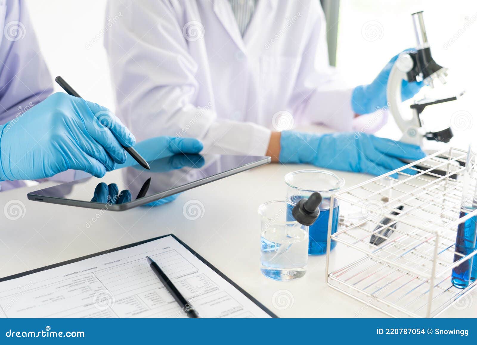 Attractive Young Scientist Team in Lab Coat and Safety Goggles Working ...