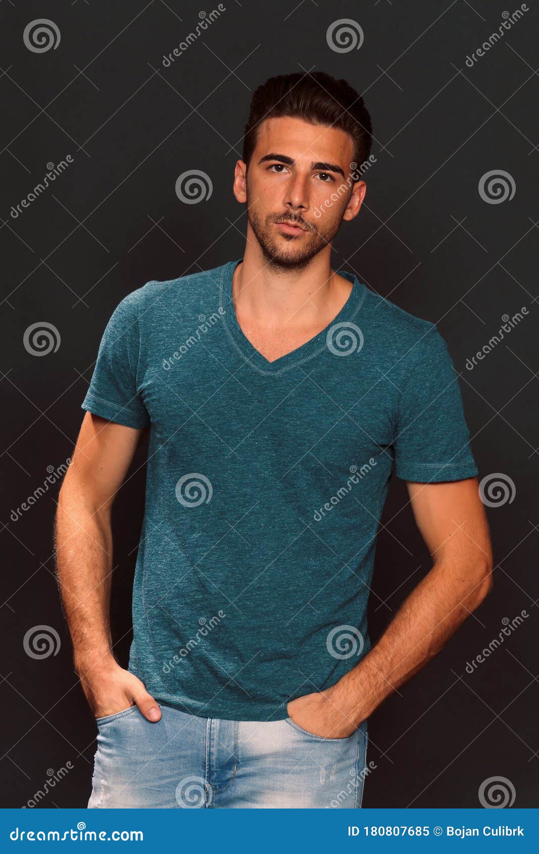 Attractive Young Tanned Male Model with Short Hair Posing in Studio on ...