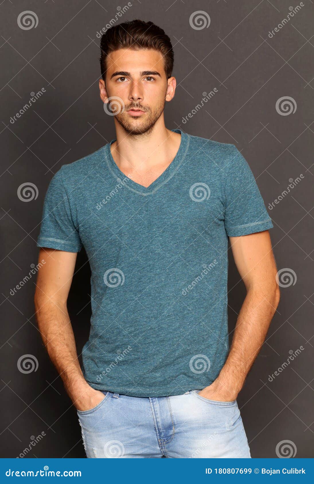 Attractive Young Tanned Male Model with Short Hair Posing in Studio on ...