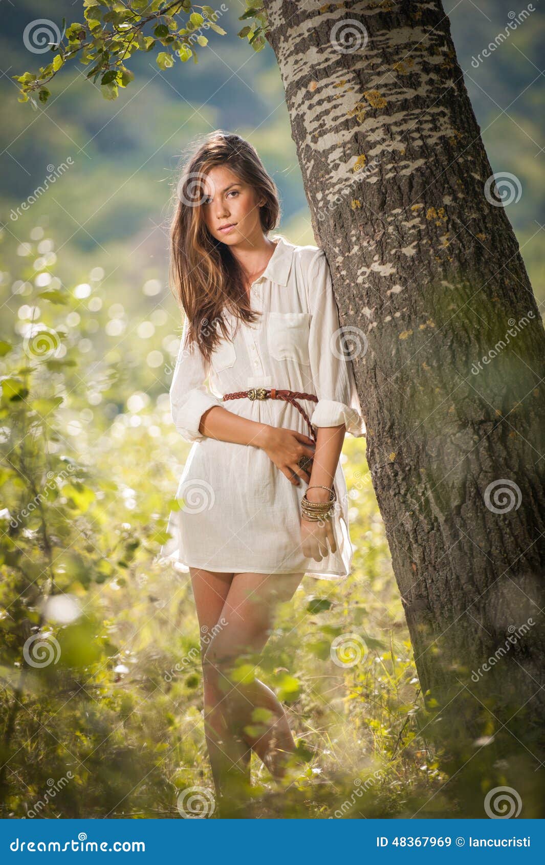 Young Girl Posing in Tree at Park in Chula Vista stock photo - OFFSET