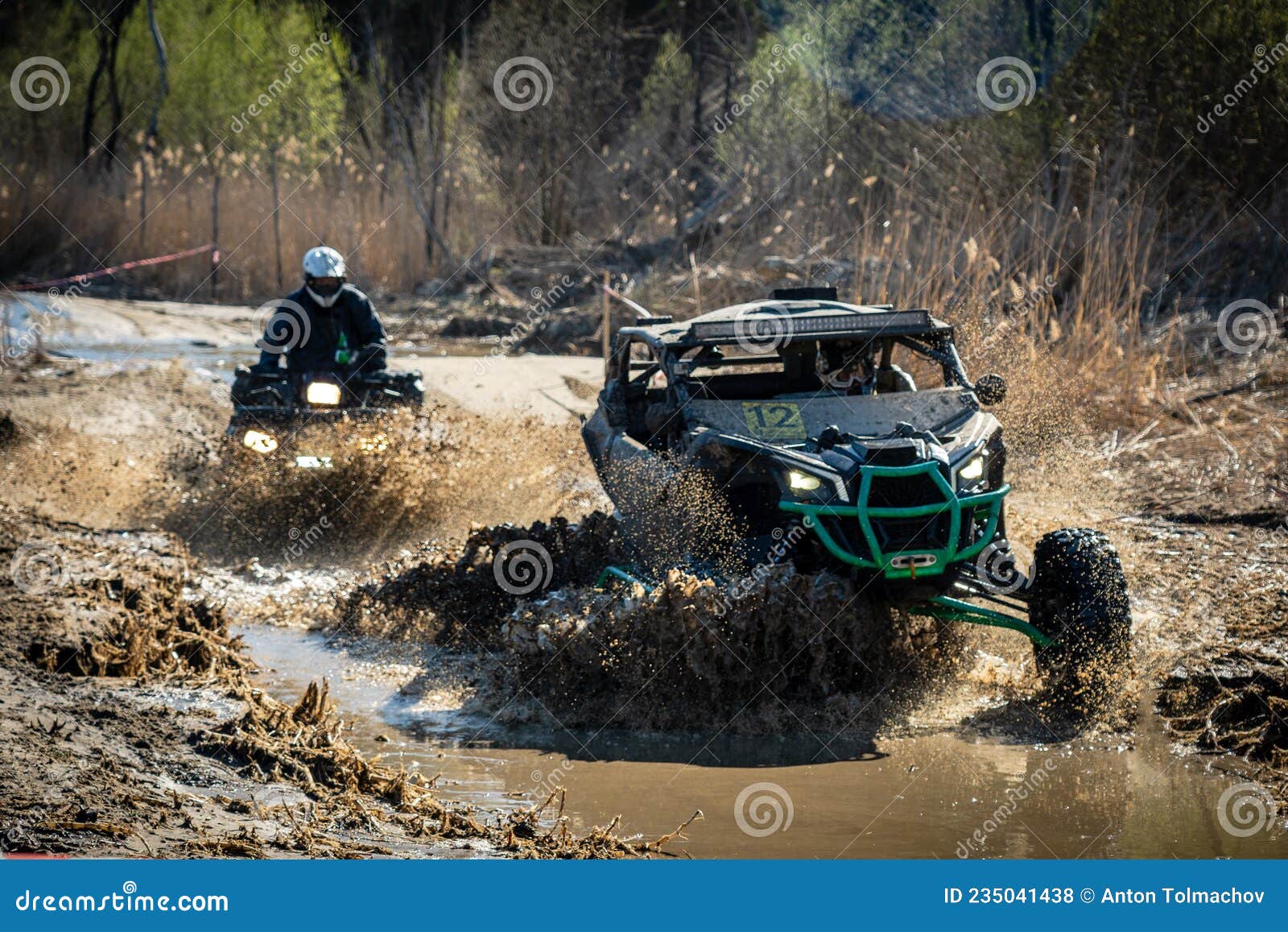 ATV and UTV Riding in Hard Track with Mud Splash. Amateur Competitions