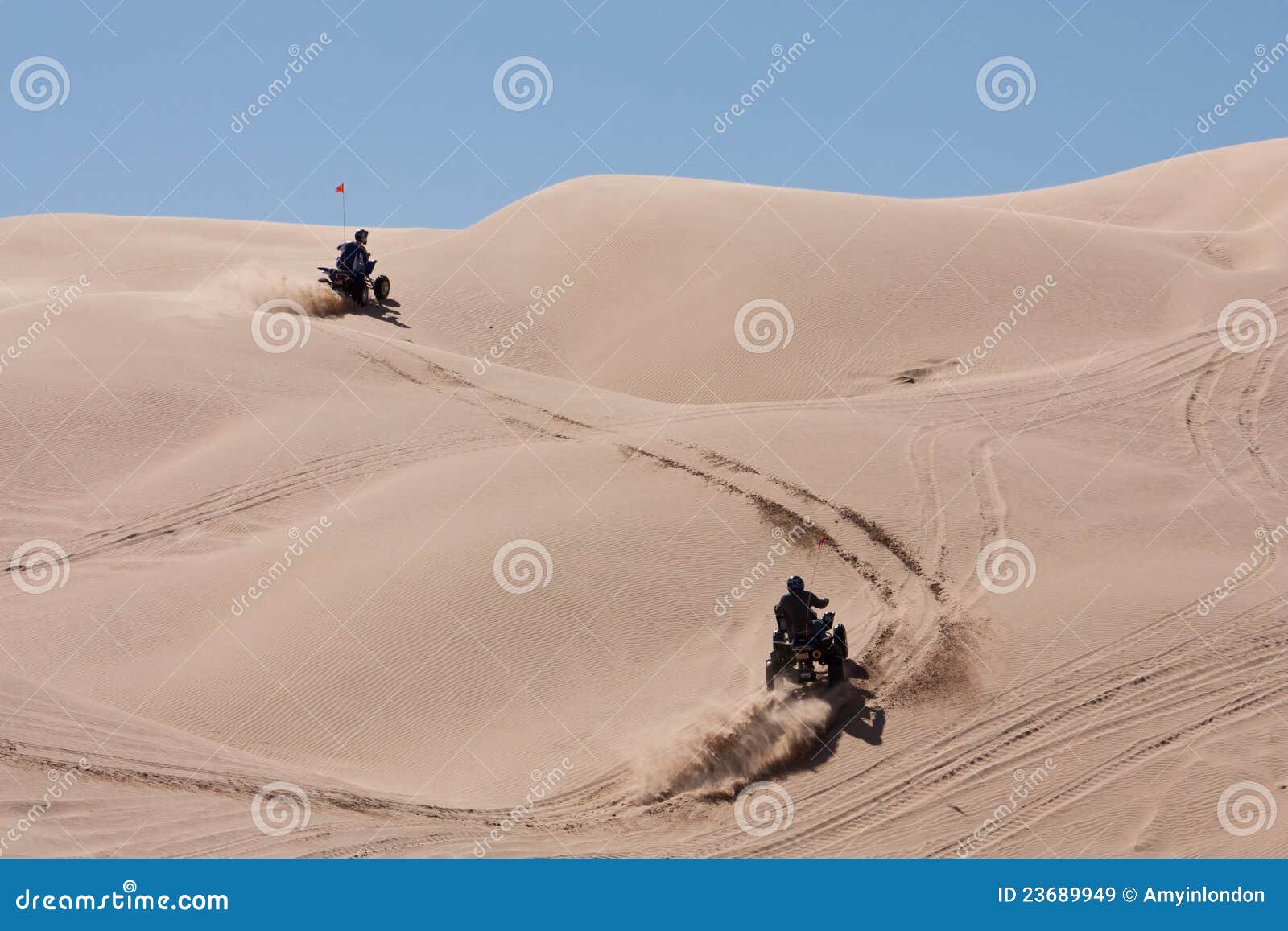 ATVs hopping the dunes stock image. Image of sport, adventure 23689949