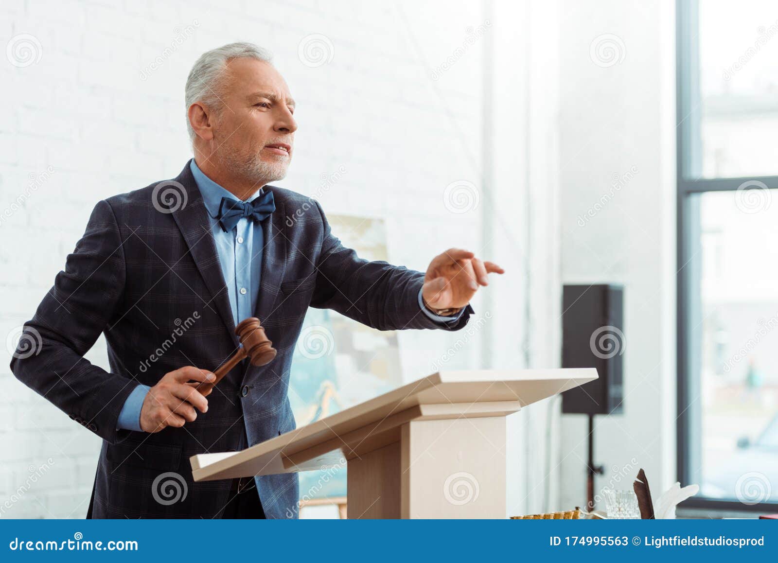 Auctioneer Holding Gavel and Pointing with Stock Image Image of