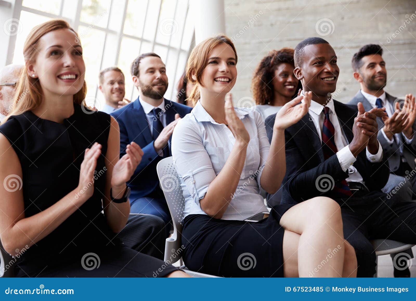 audience applauding speaker at business conference