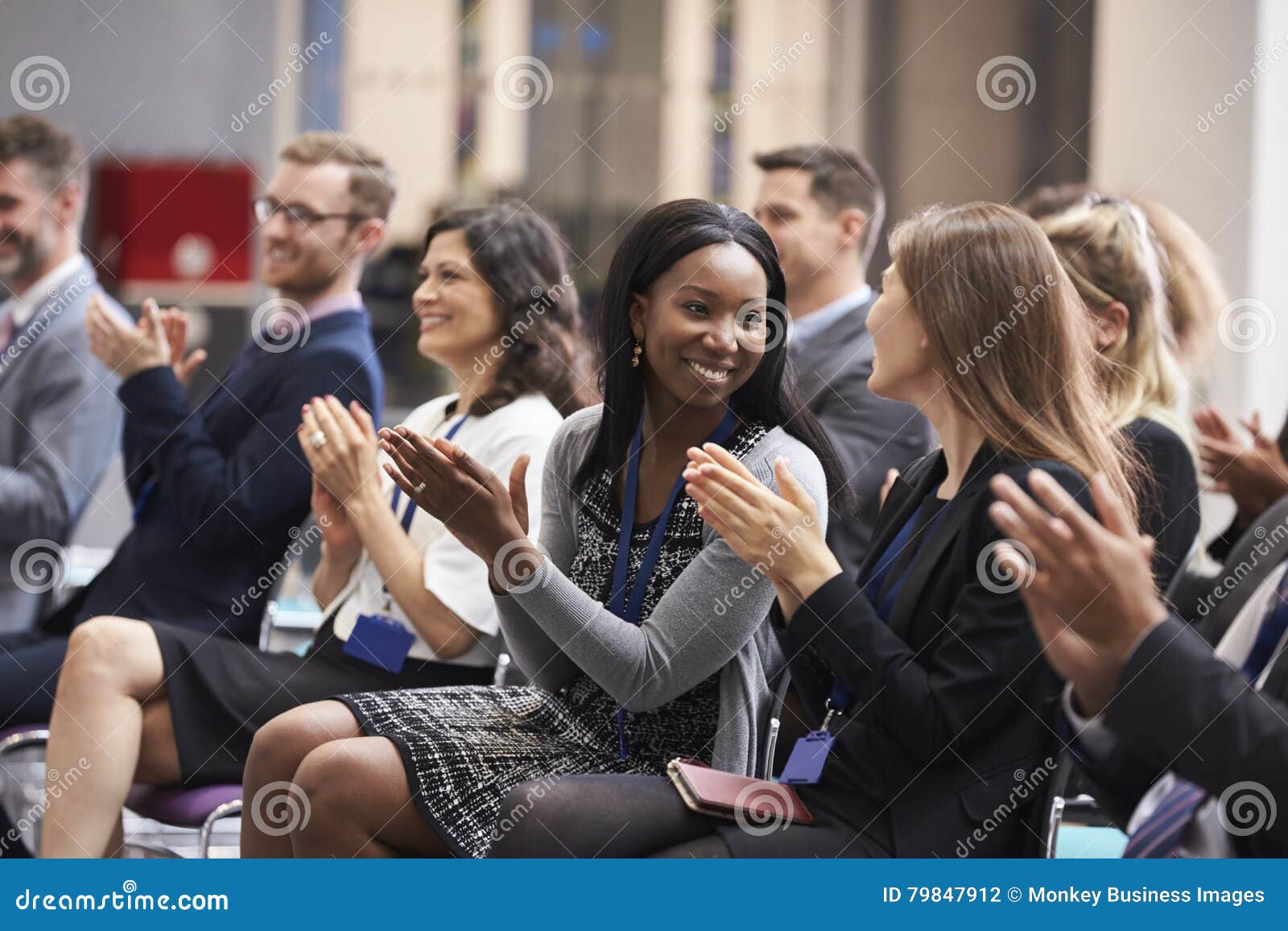 audience applauding speaker after conference presentation
