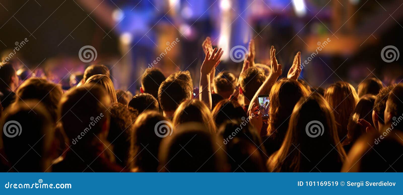 Audience with Hands Raised at a Music Festival and Lights Streaming ...