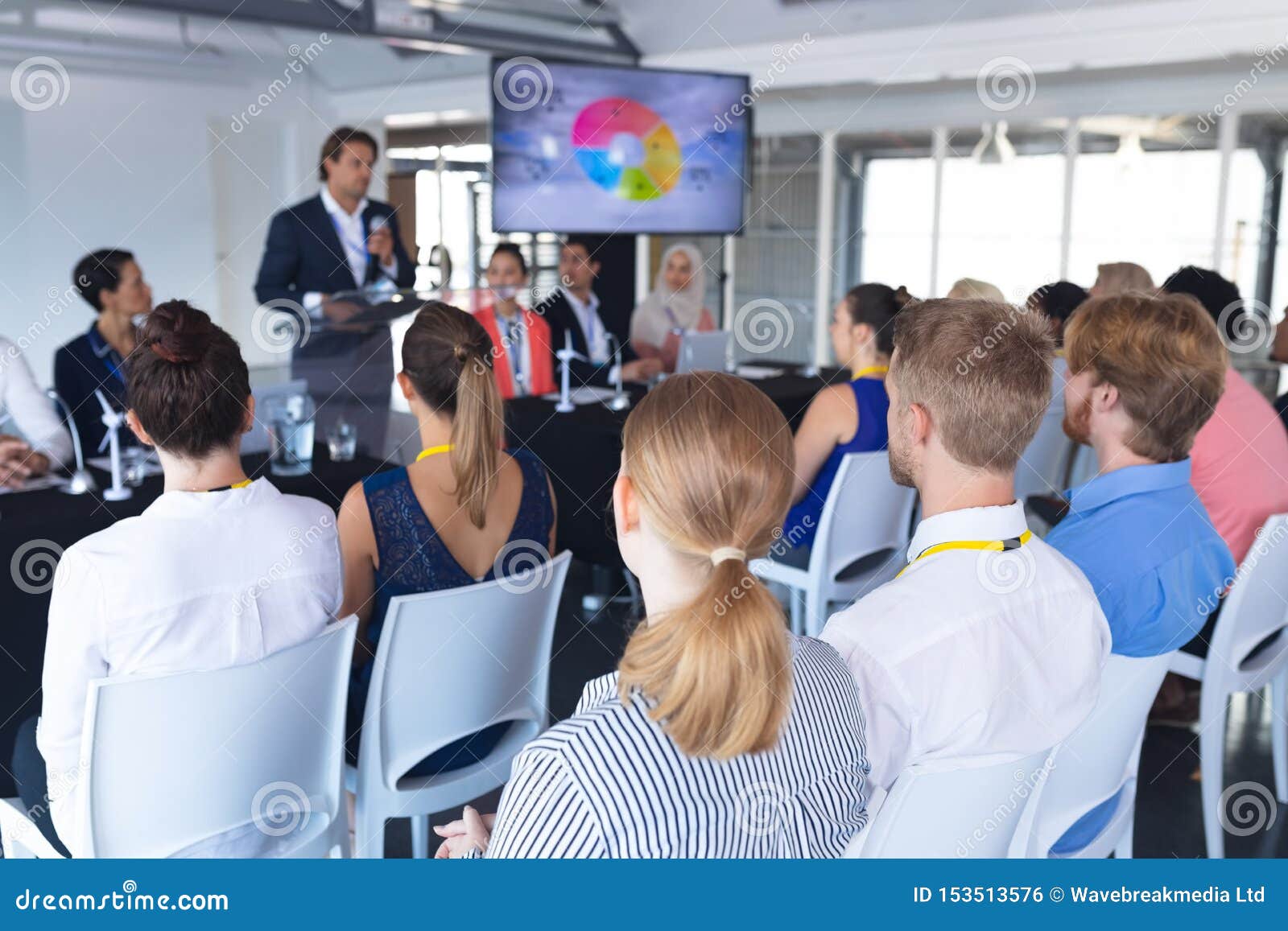 Audience Listening Male Speaker in a Business Conference Stock Photo