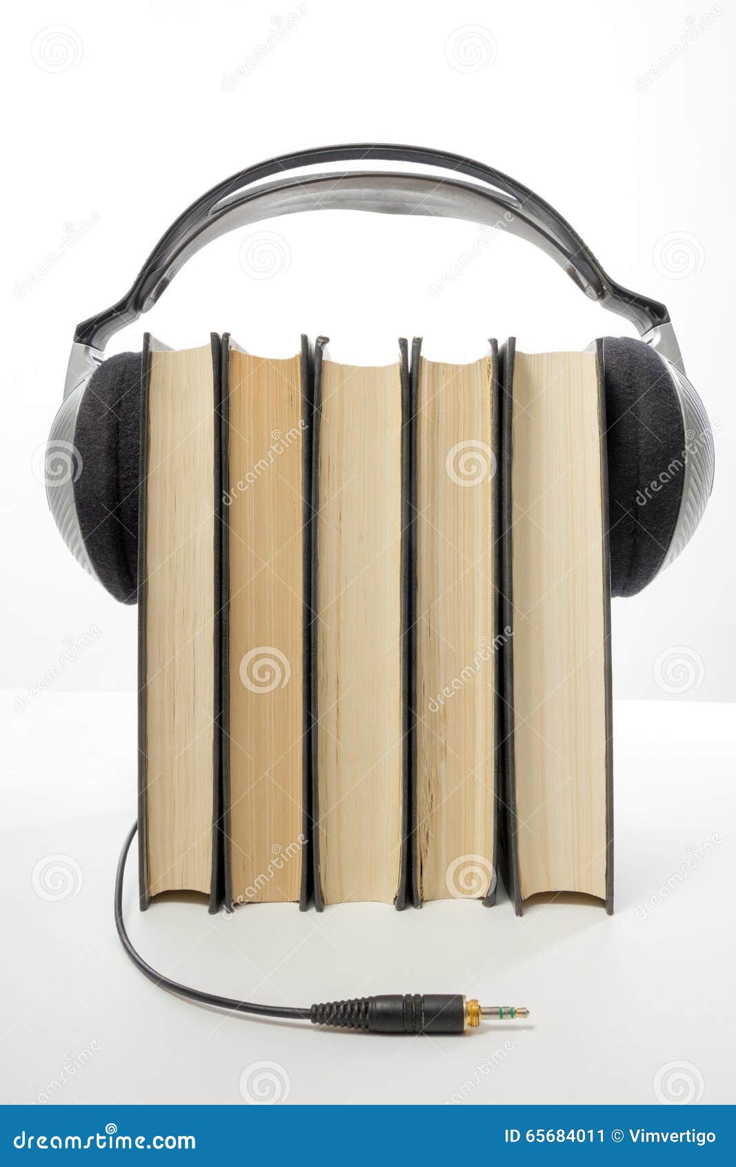 Audio Book Stack of Hardback Books and Electronic Reader. Electronic
