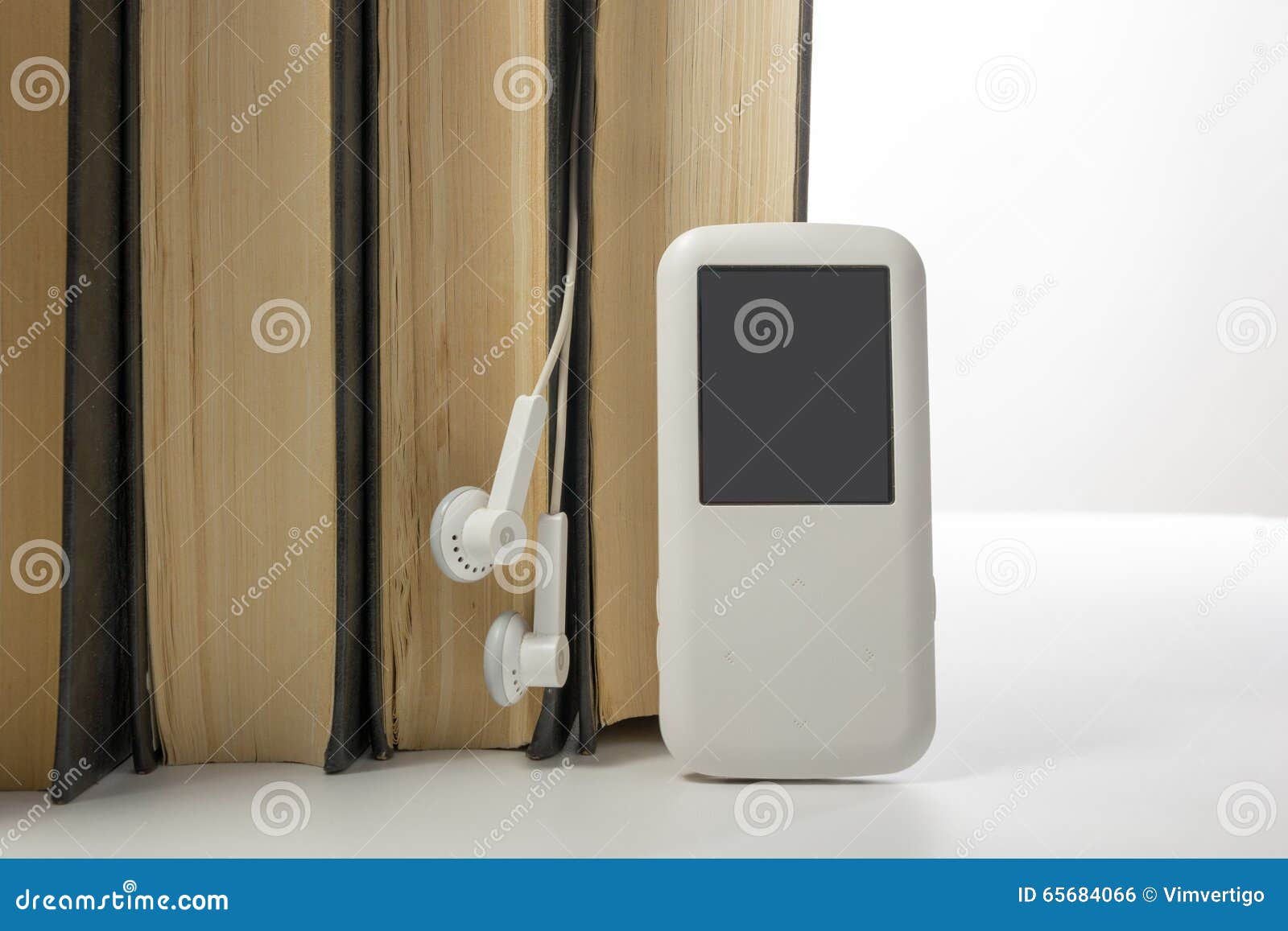 Audio Book Stack of Hardback Books and Electronic Reader. Electronic
