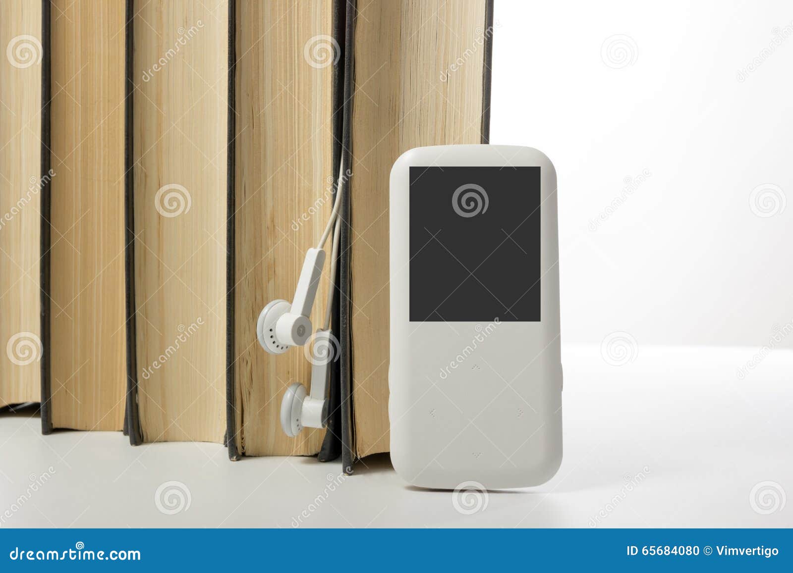 Audio Book Stack of Hardback Books and Electronic Reader. Electronic