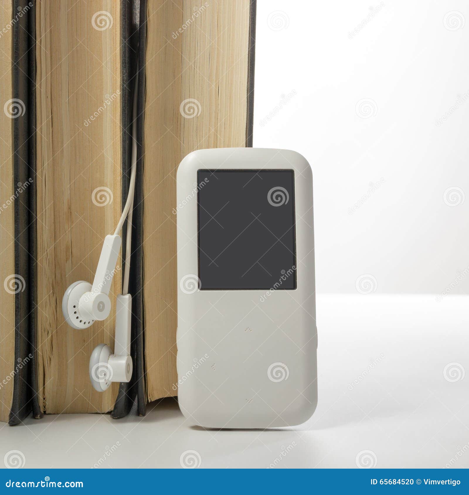 Audio Book Stack of Hardback Books and Electronic Reader. Electronic