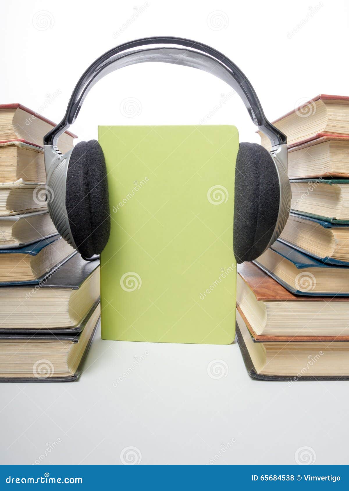 Audio Book Stack of Hardback Books and Electronic Reader. Electronic