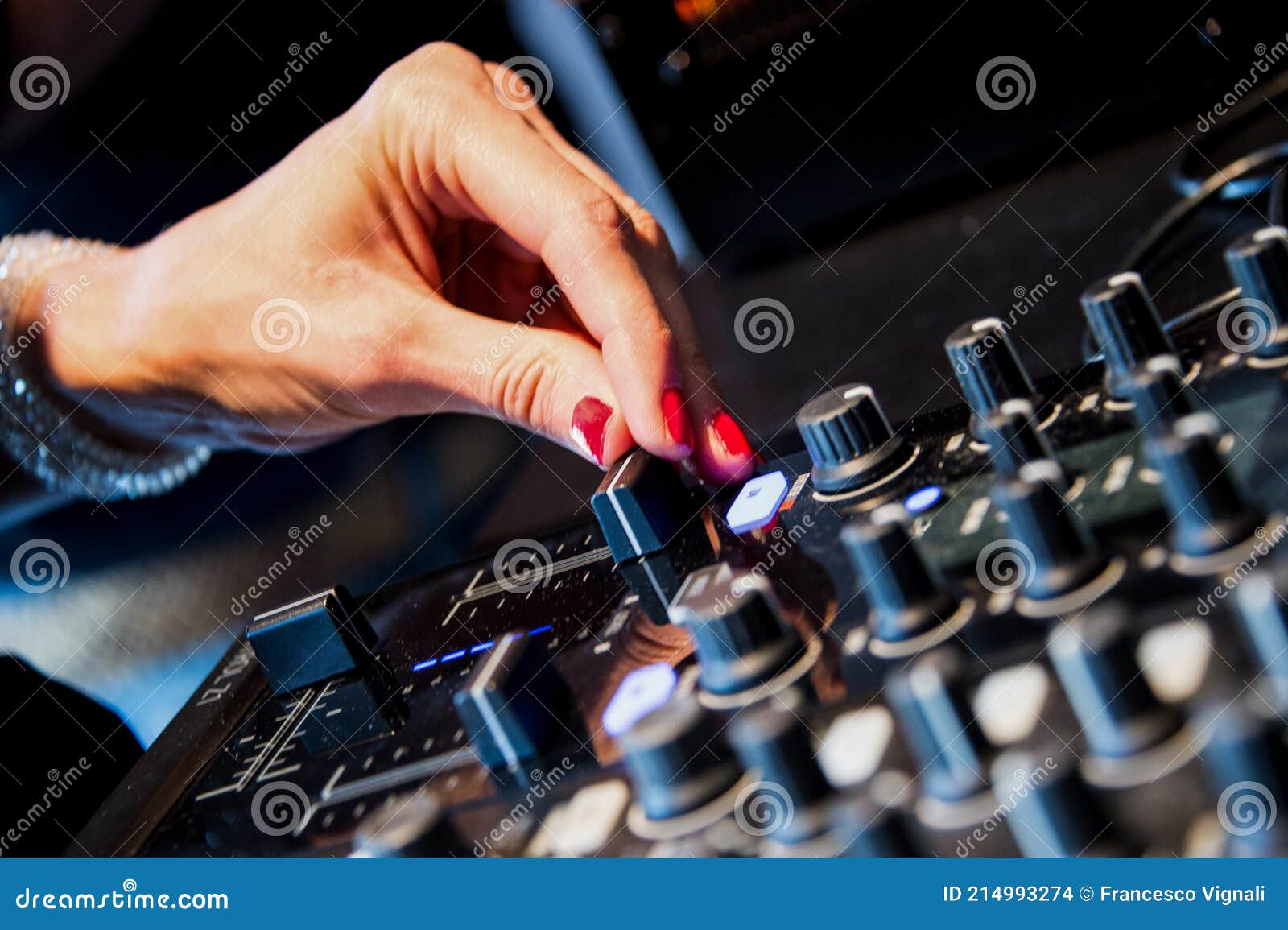 audio mixer console and professional sound mixing. a hand is adjusting audio mixer with buttons and sliders. mixer console for mus
