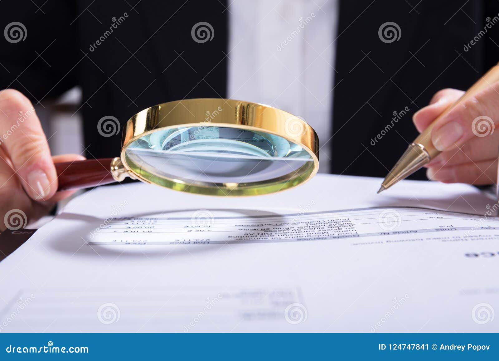 auditor inspecting financial documents at desk