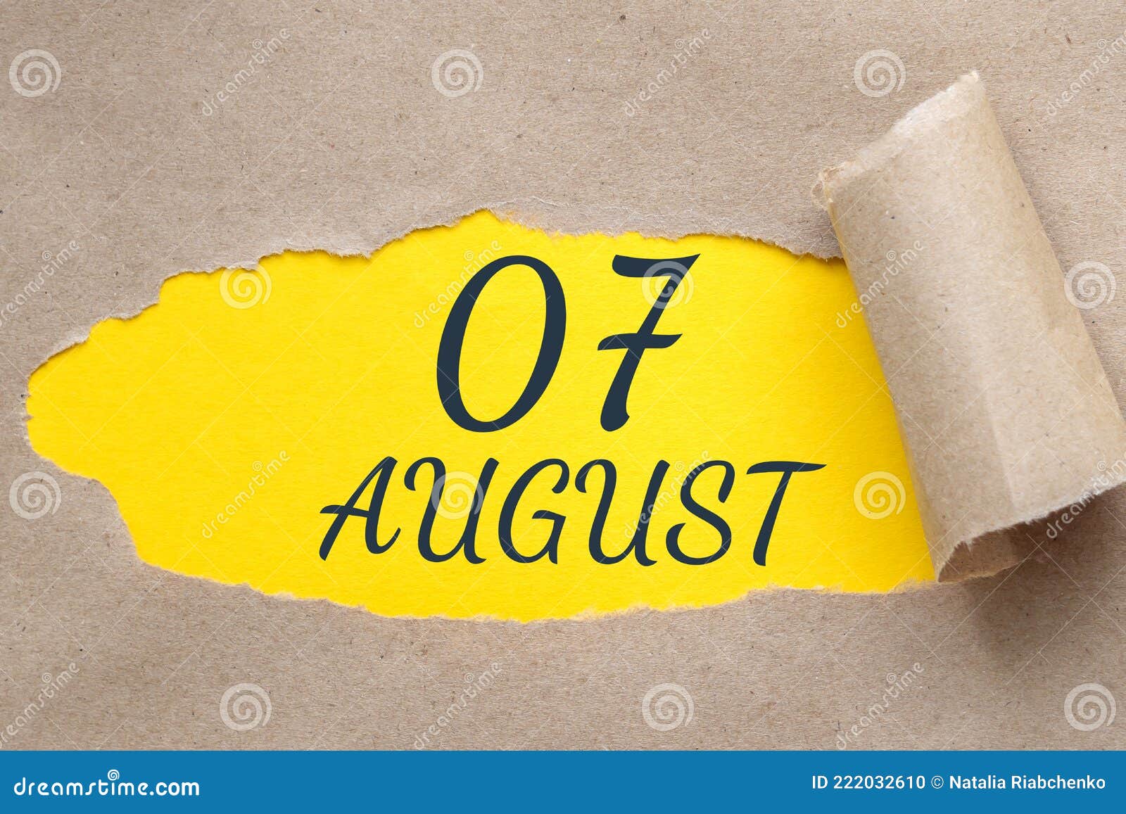 august 07. 07th day of the month, calendar date.hole in paper with edges torn off. yellow background is visible through