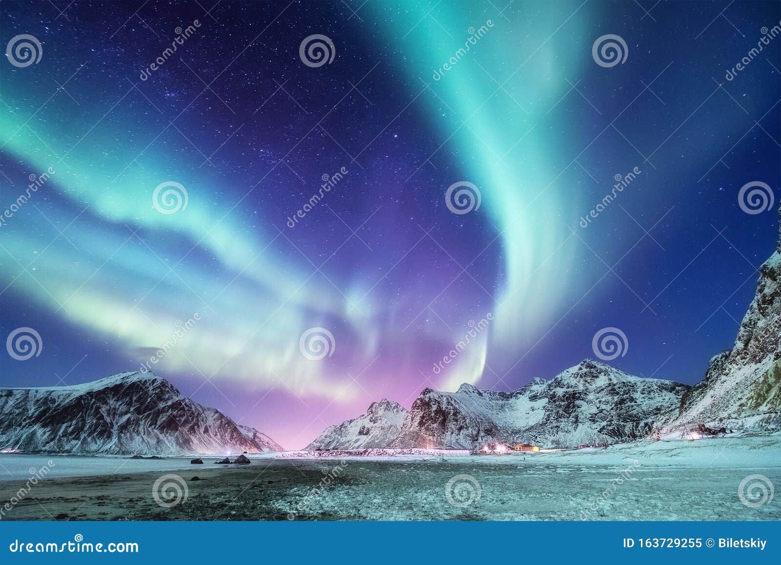 aurora borealis, lofoten islands, norway. nothen light and reflection on the lake surface. winter landscape at the night time.