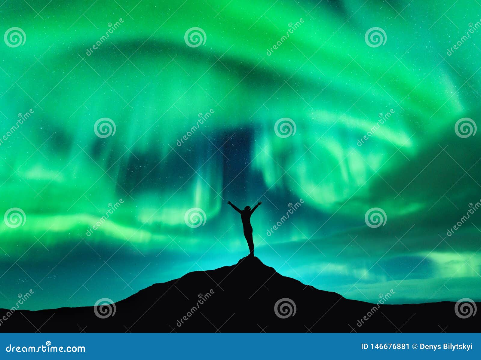 aurora borealis and silhouette of a woman with raised up arms