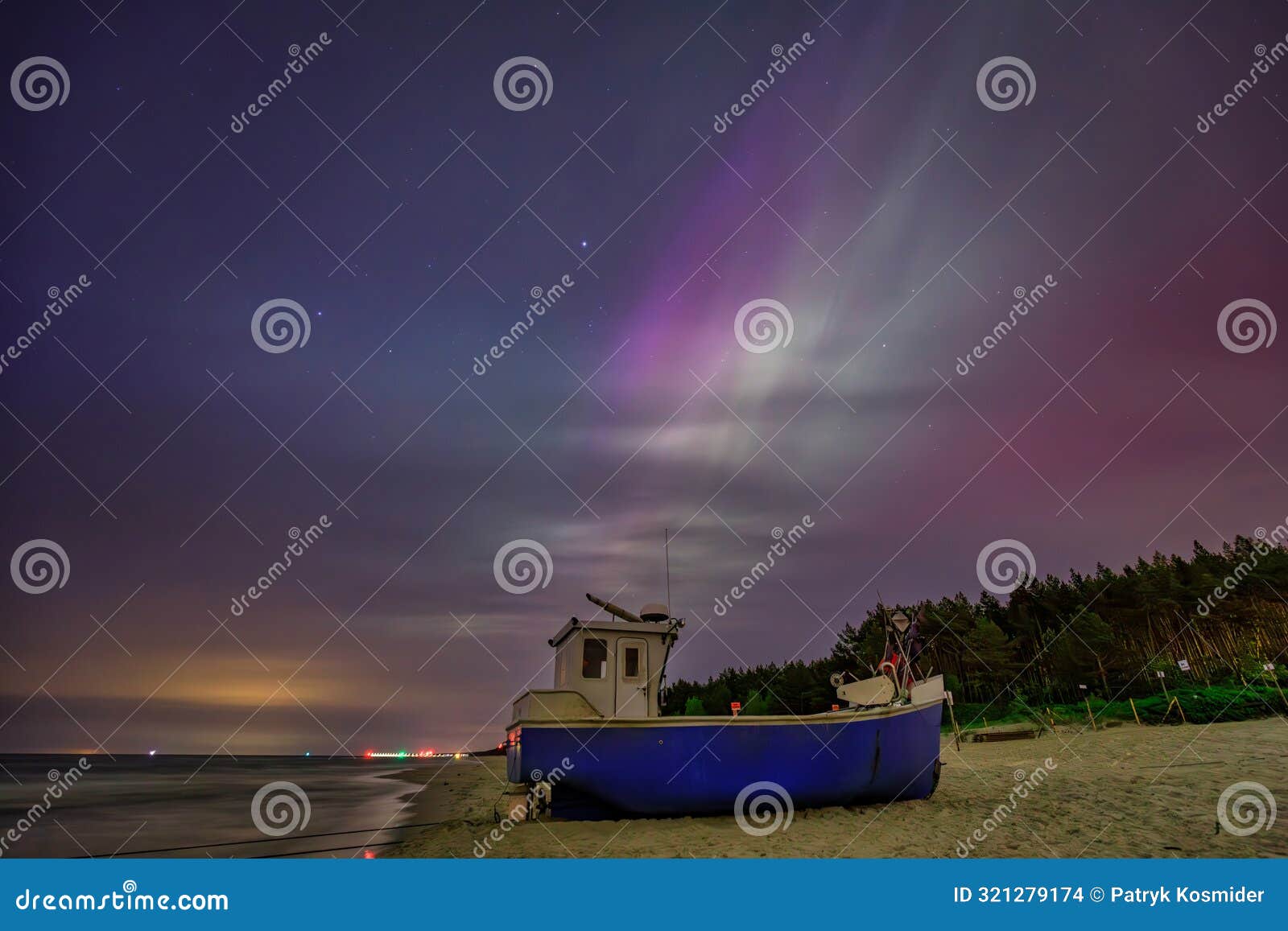 aurora over the baltic sea on the beach in katy rybackie with fishing boat in poland