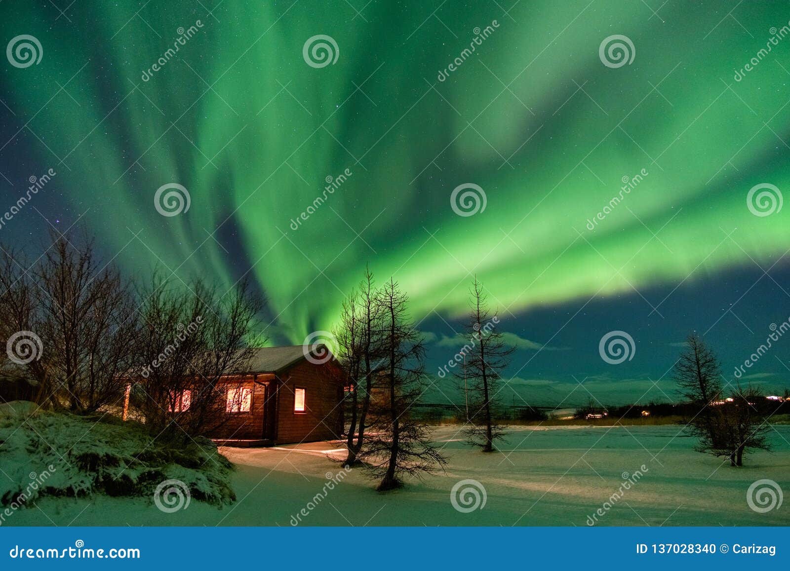 aurora over cottage in iceland