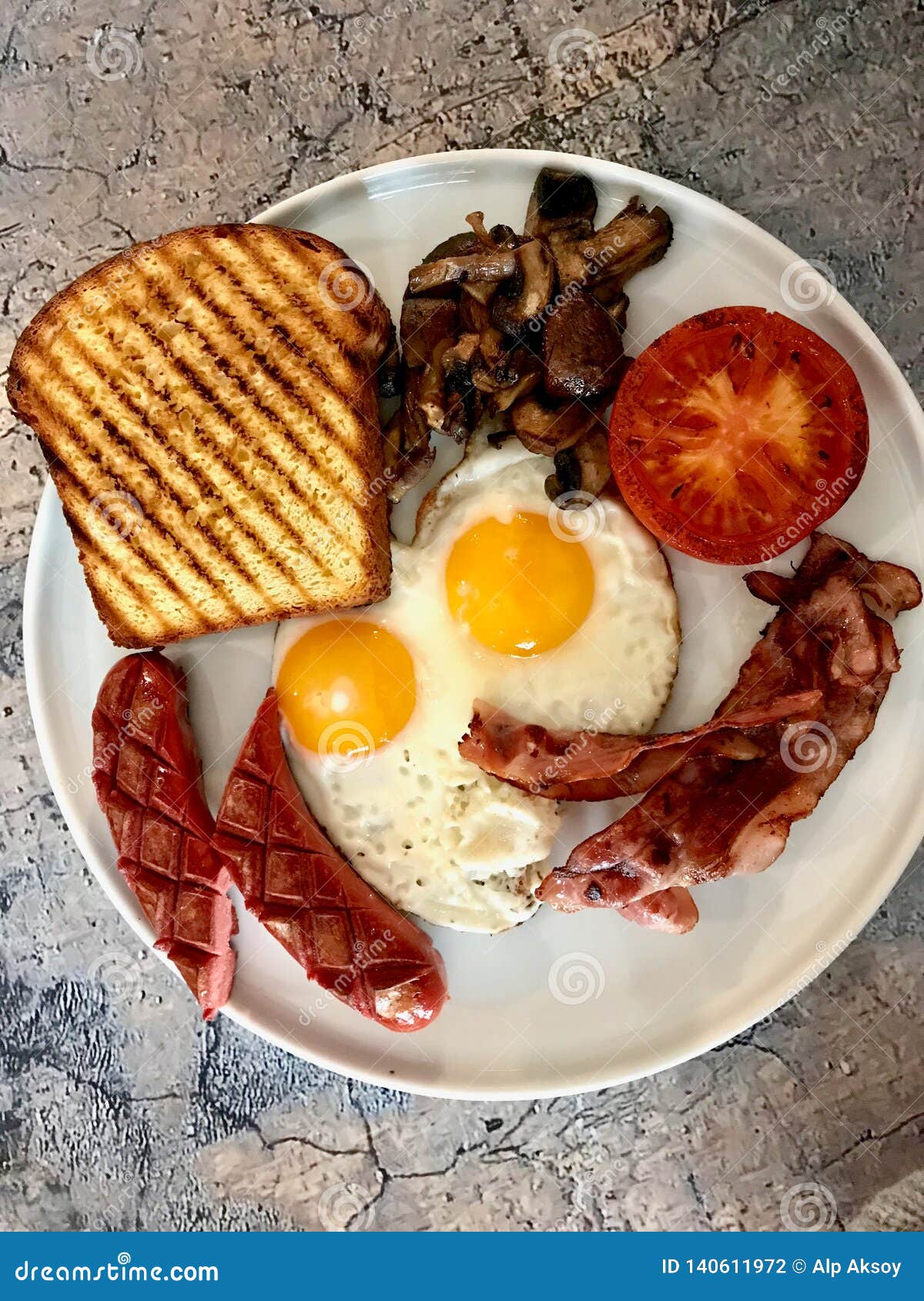 Aussie / Australian Breakfast with Brioche Toast, Fried Eggs, Crispy Bacon Sausage and Mushrooms Stock Photo - Image roasted, bread: 140611972