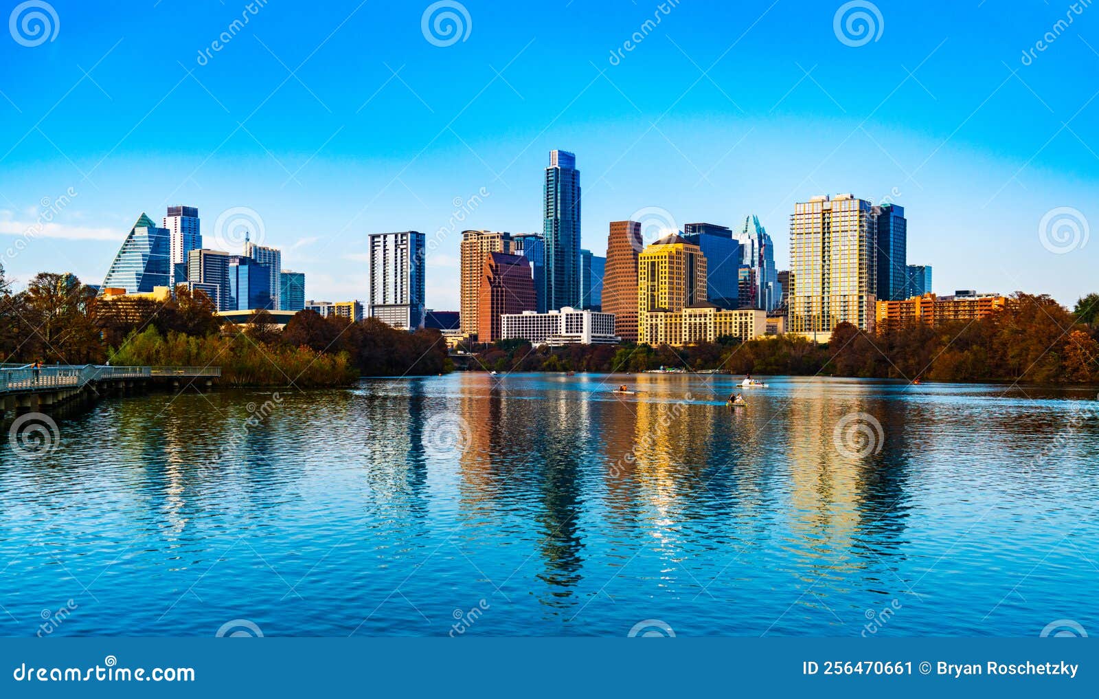 austin texas reflections of a blue town lake and sunset skyline at the pedestrian bridge on a gorgeous clear sky sunny afternoon