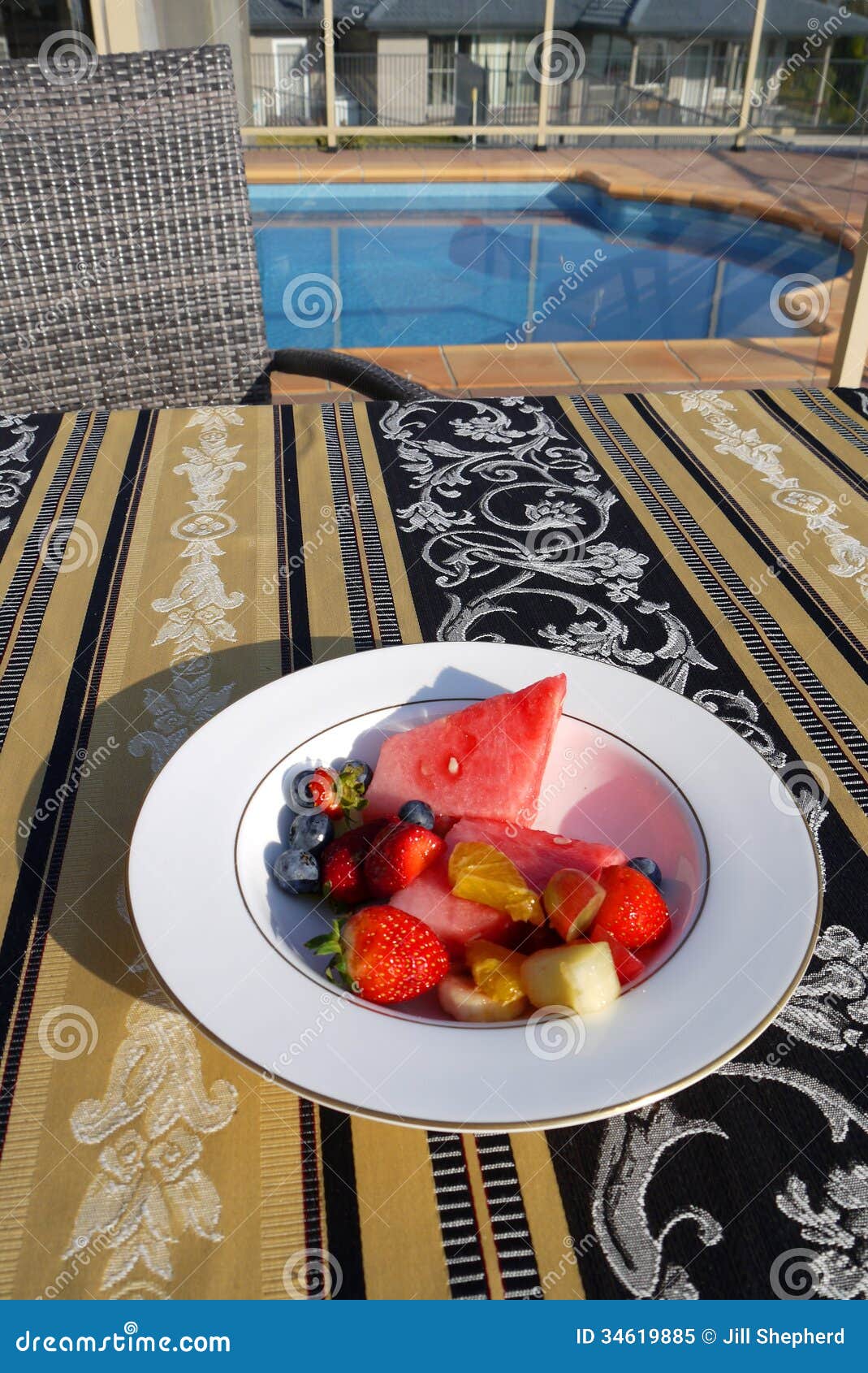 Australia: outdoor breakfast by pool. Breakfast fresh fruit salad by outdoor swimming pool