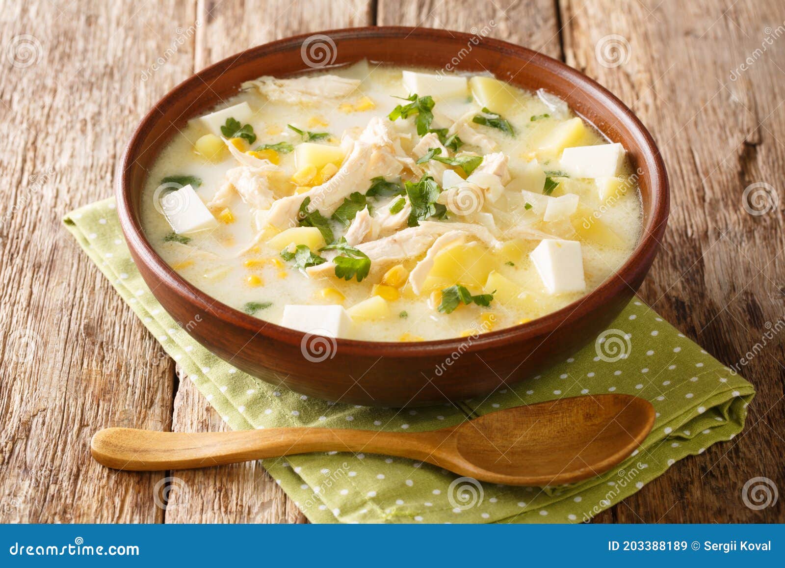 authentic chupe andino soup made from chicken, corn, fresh cheese, vegetables and cream close-up in a bowl. horizontal