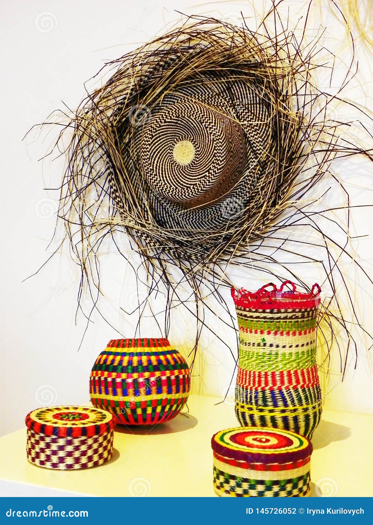 authentic panama hat or paja toquilla hat and colored baskets, ecuador