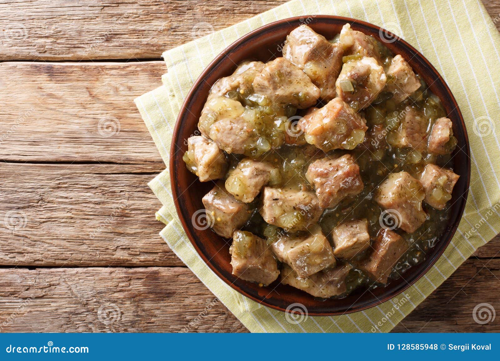 this authentic pork chile verde recipe. tender pieces of pork slow cooked with a green chile sauce (salsa verde) closeup. horizon