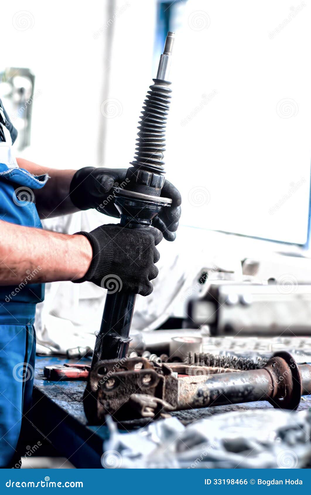 Auto Engineer Mechanic Working on Car Shock Absorber Stock Photo