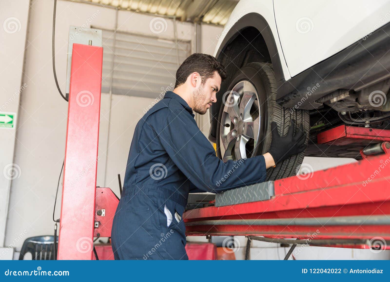 Auto Mechanic Adjusting Car Tire In Repair Shop Stock Photo Image of