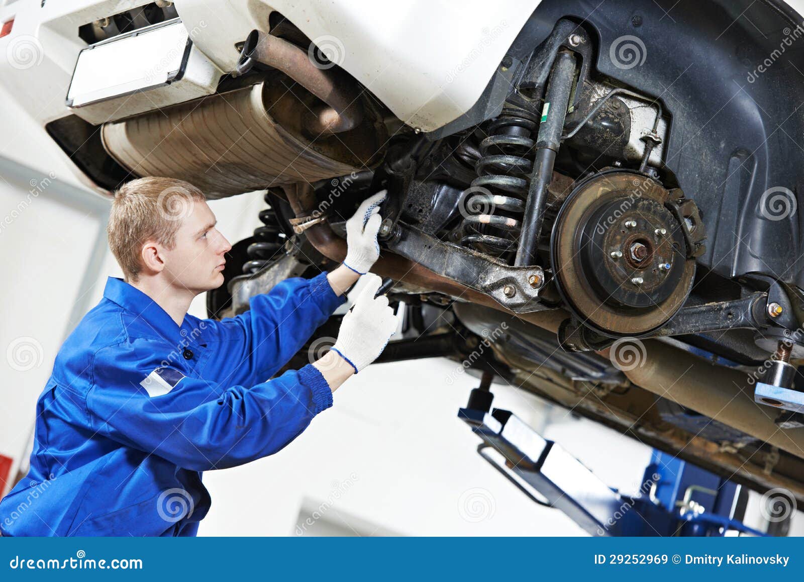 auto mechanic at car suspension repair work