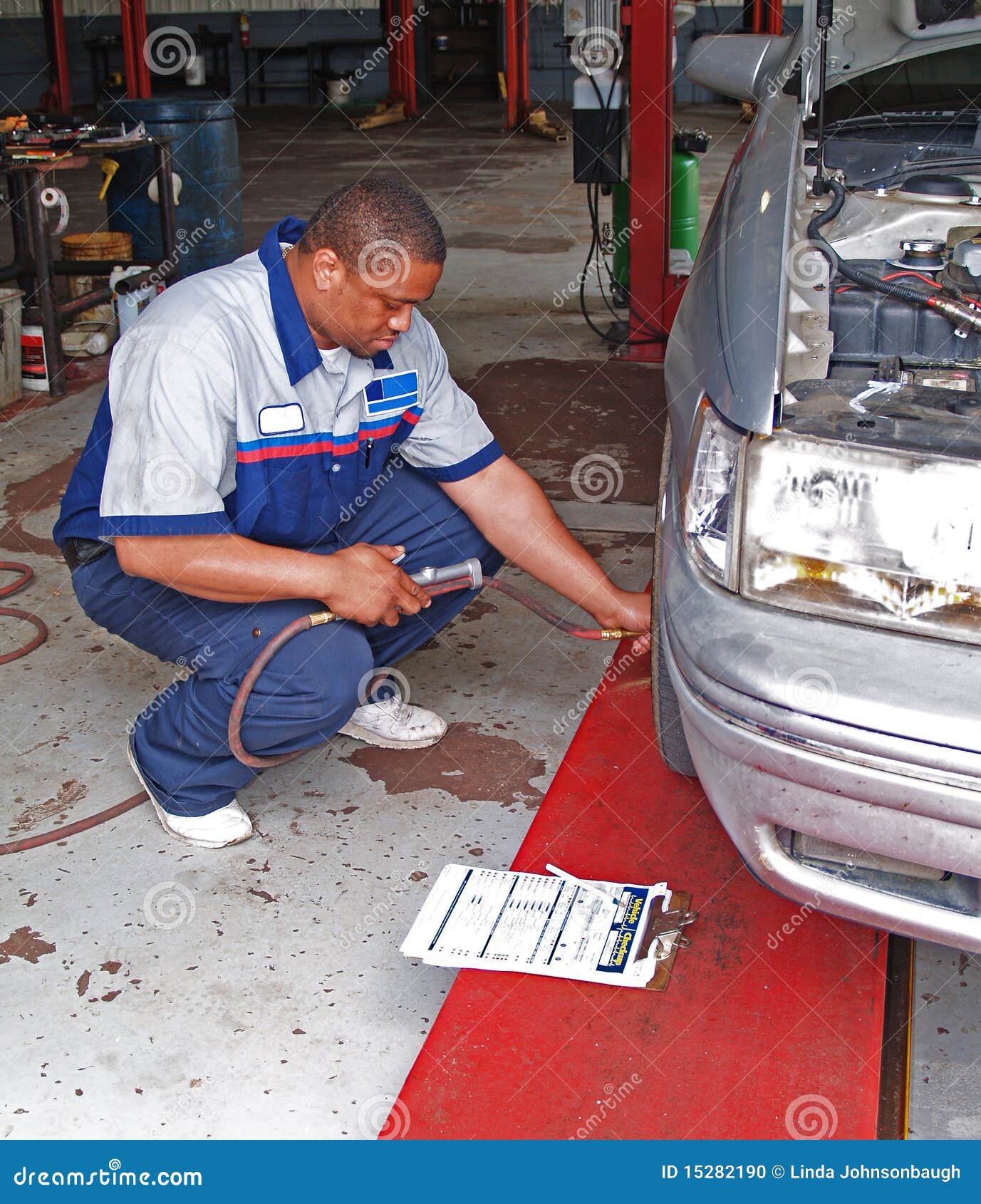 Auto Mechanic Performing Tire Pressure Inspection Stock Photo Image