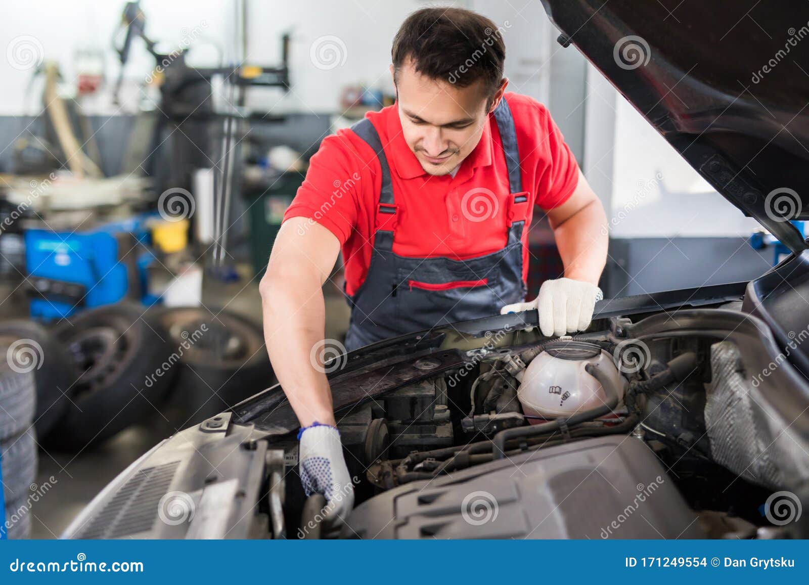 Auto Mechanic or Technician Checking Car Engine at the Garage Stock