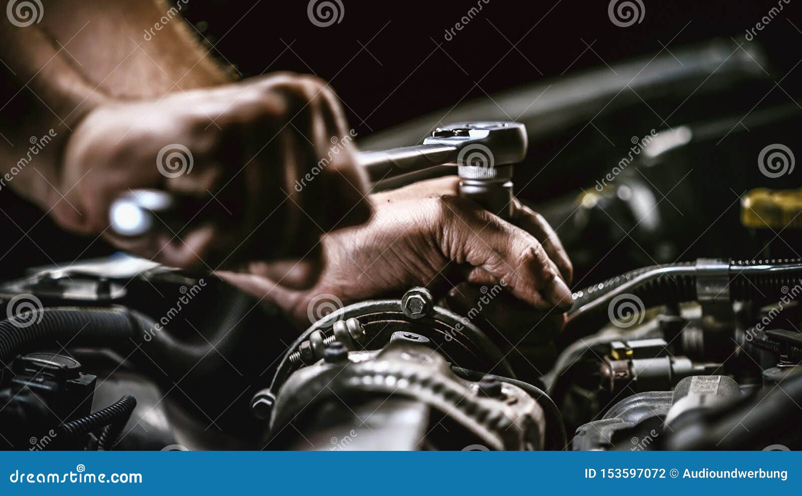 auto mechanic working on car engine in mechanics garage. repair service