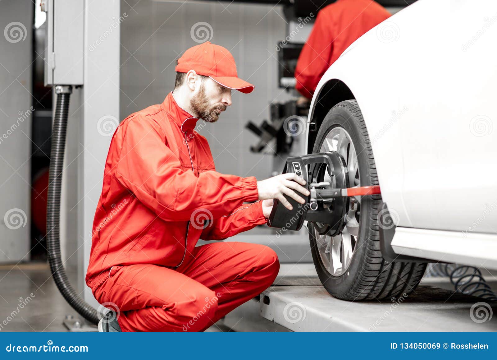 Auto Mechanics Making Wheel Alignment At The Car Service Stock Image