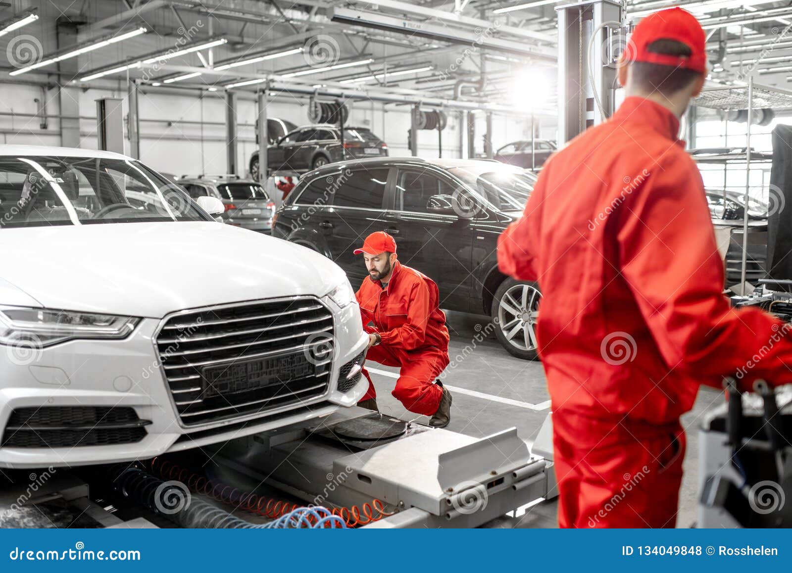 Auto Mechanics Serving Luxury Car at the Car Service Stock Photo