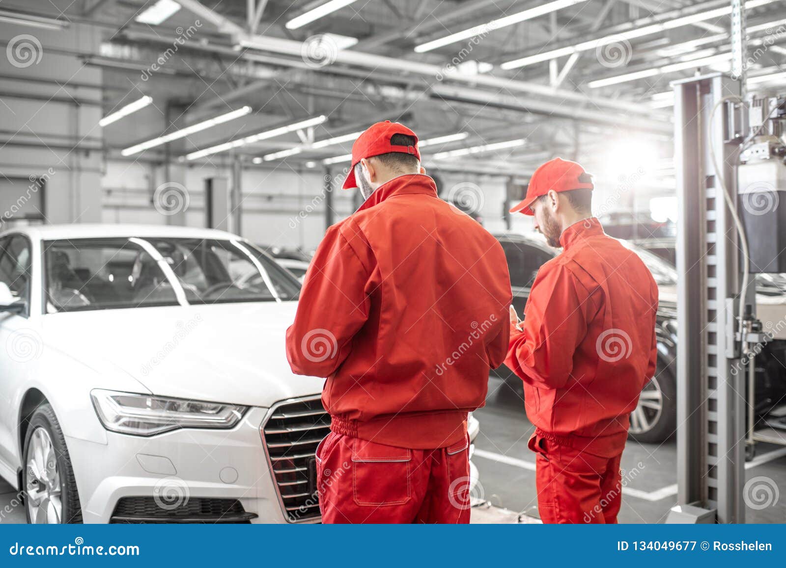 Auto Mechanics Serving Luxury Car at the Car Service Stock Image