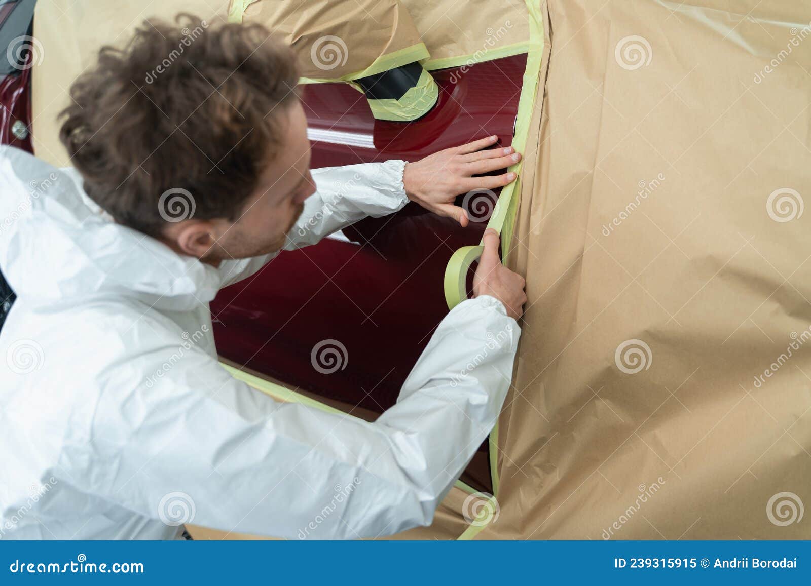 Auto Painter Masking Car Body with Tape and Paper before Repaint