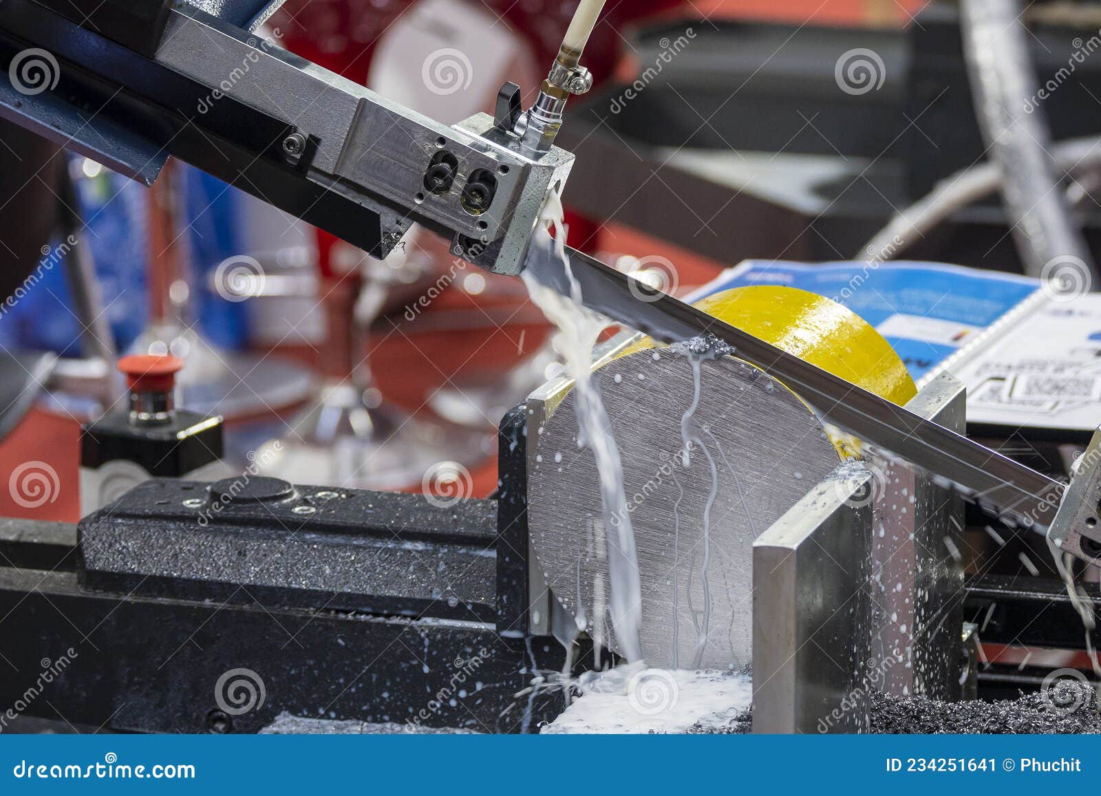 The Automatic Band Saw Machine Cutting the Metal Bar with Water Base
