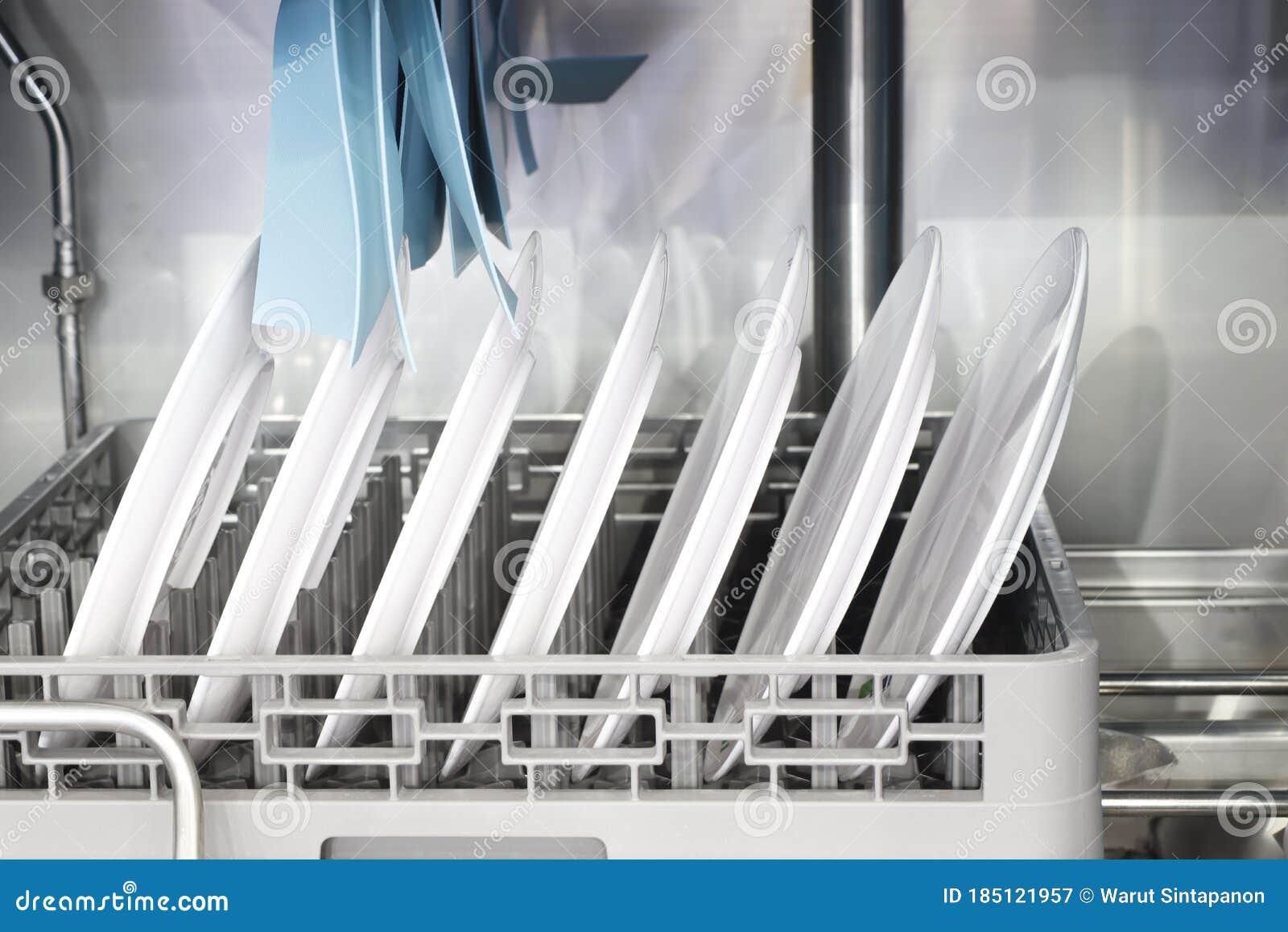 The Automatic Dishwasher with White Clean Dishes in Basket .for