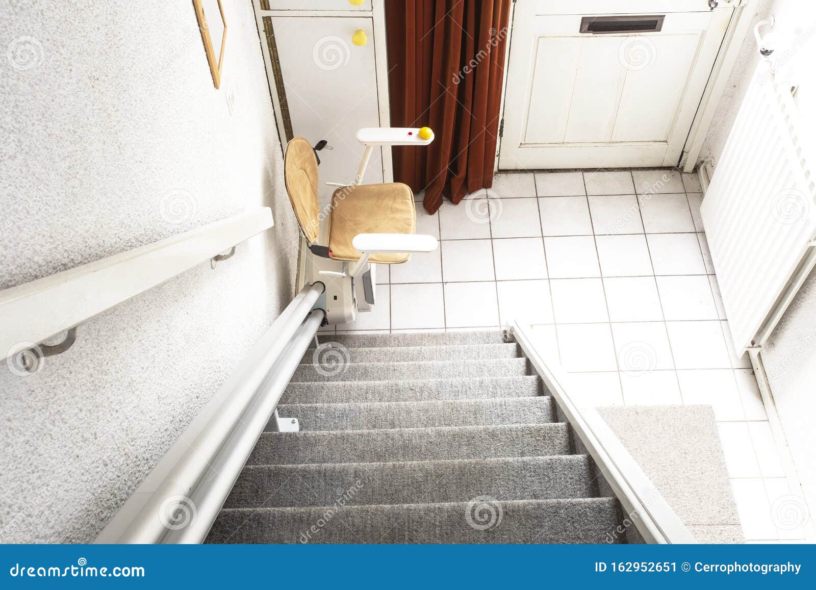 automatic stair lift on staircase taking elderly people and disabled persons up and down in a house