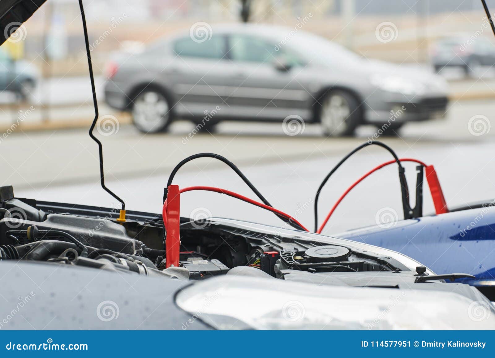 automobile help. booster jumper cables charging automobile discharged battery
