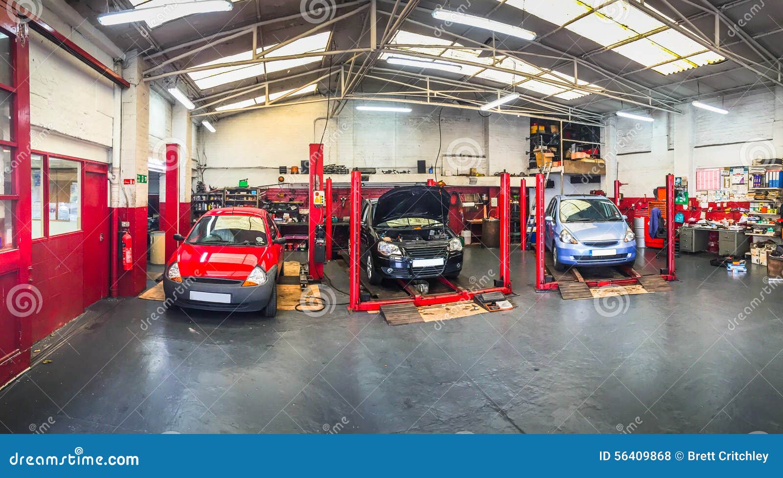 Automotive car repair shop / service bays garage with vehicles on Automotive car repair shop / service bays garage with vehicles on