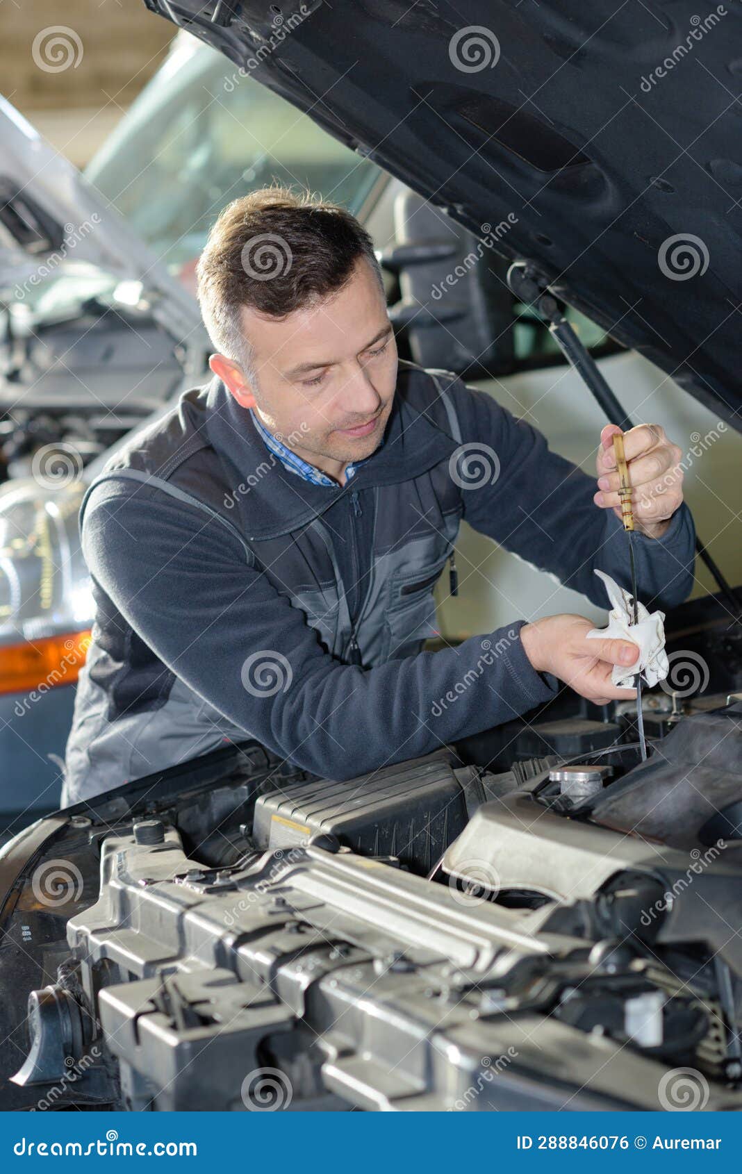Automotive Specialist Adjusting Engine in Garage Stock Photo Image of