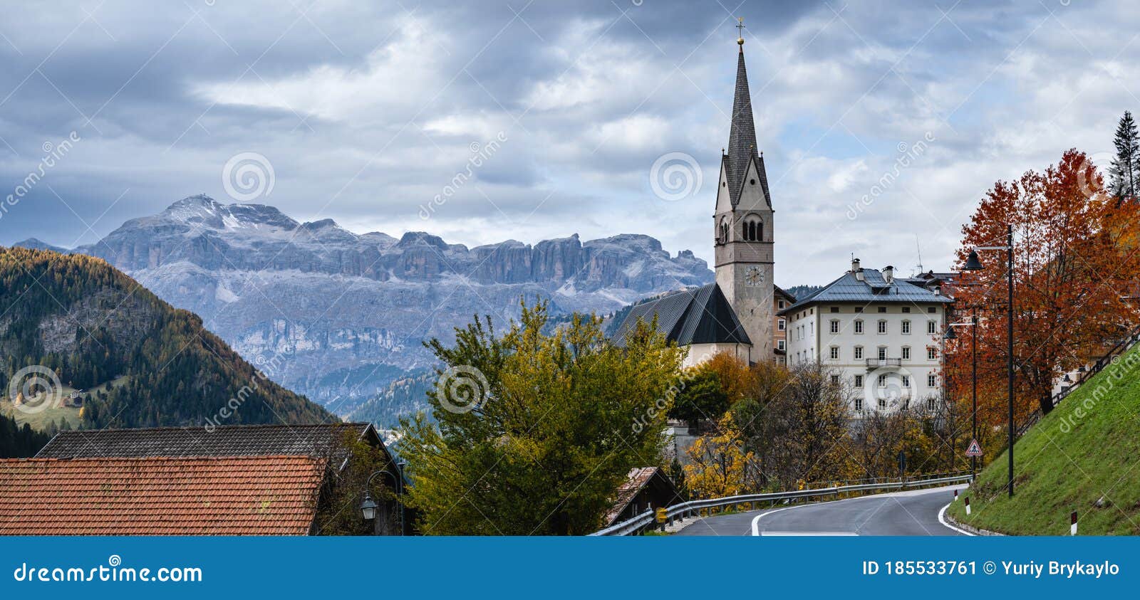 autumn dolomites village and old church, livinallongo del col di lana, italy